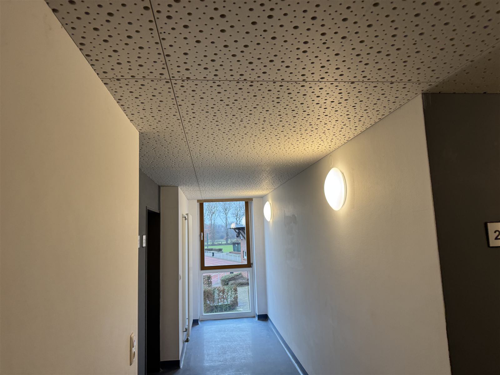 Fertiggestellter Flur mit Akustikdecke und Tageslicht